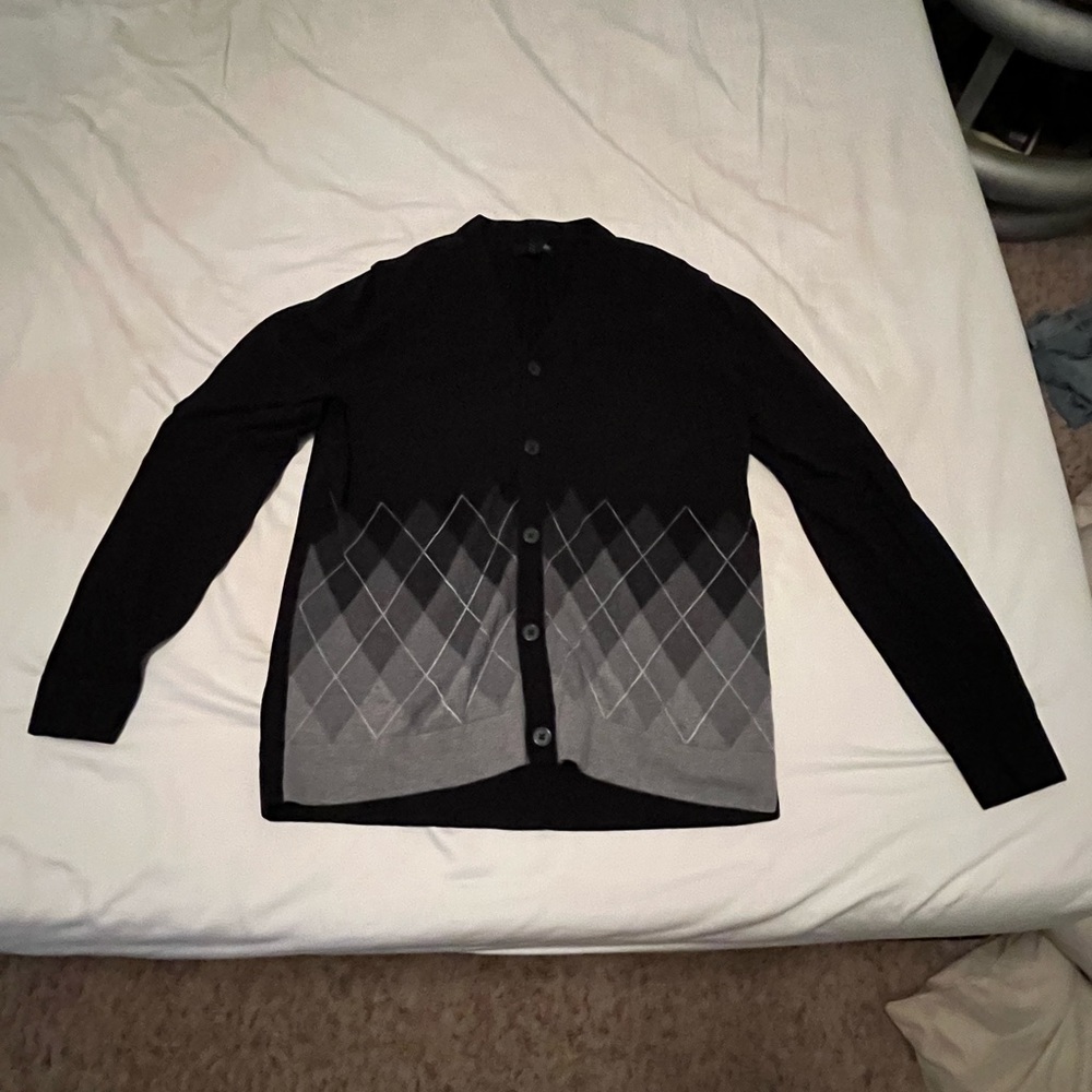 A black and grey plaid, J. Ferrar cardigan sweater. Size Large.